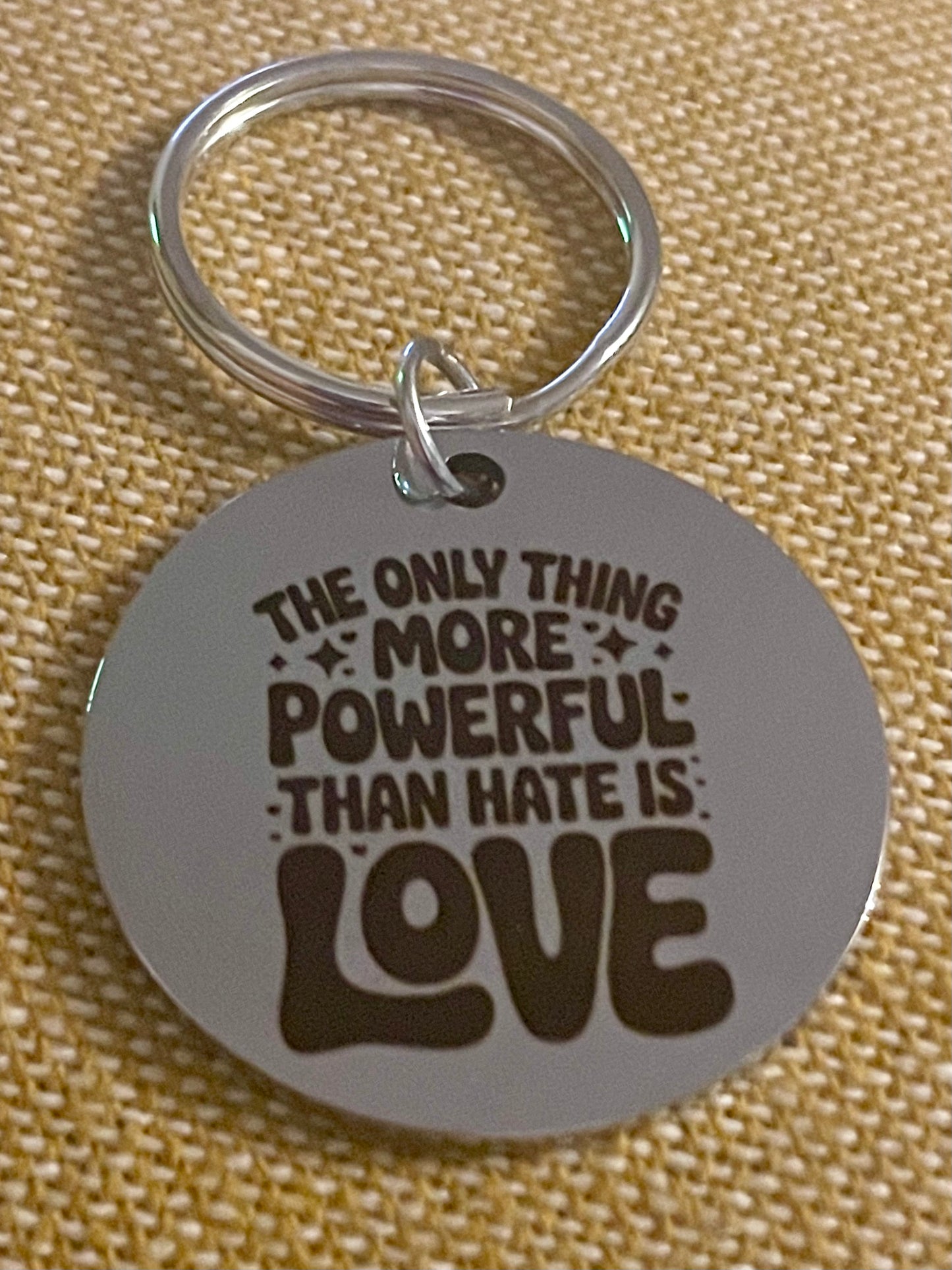 The Only Thing More Powerful Than Hate is Love Keychain engraved on silver round keychain