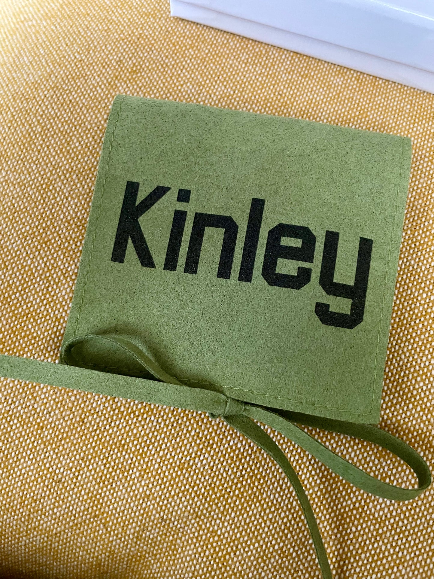 Green  microfiber fabric with 'Kinley' engraved into it